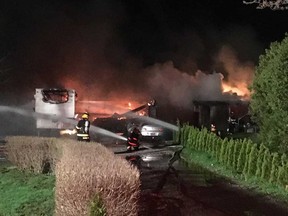 Leamington firefighters work to extinguish a blaze that started in a garage and spread to a trailer and a barn early May 2, 2019.