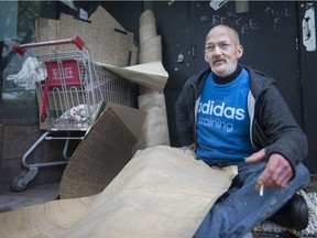 John Rollo, a homeless man who is often found in the downtown core, is pictured with what's left of what he found in the dumpster behind the Windsor Public Library's downtown branch, Thursday, May 30, 2019. Rollo found documents, sketches and maps, most of which the library has  reclaimed.