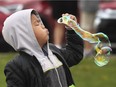 Darvin Datinginoo, 7, blows a bubble during the annual Mayor's Walk event on Saturday, May 18, 2019.