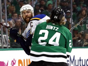 St. Louis Blues' Alex Pietrangelo is checked by Dallas Stars' Roope Hintz (24), of Finland, during the first period in Game 4 of an NHL second-round hockey playoff series Wednesday, May 1, 2019, in Dallas.