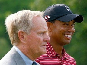 In this June 7, 2009, file photo, Jack Nicklaus waits with Tiger Woods after his one-stroke victory at the Memorial Tournament at the Muirfield Village Golf Club in Dublin, Ohio.