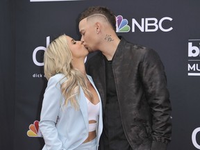 Katelyn Jae, left, and Kane Brown kiss as they arrive at the Billboard Music Awards on Wednesday, May 1, 2019, at the MGM Grand Garden Arena in Las Vegas.