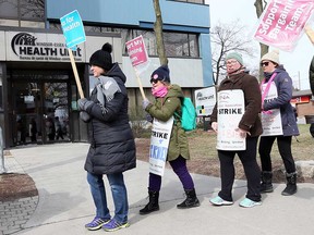 Striking members of Ontario Nurses' Association Local 8 walk the picket line outside the Windsor-Essex County Health Unit on April 11, 2019.