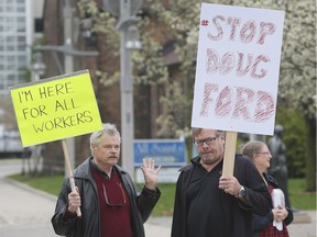 Chris Clarke, left, and Larry Hillman participate in a rally against Premier Doug Ford on Wednesday, May 1, 2019, at the downtown cenotaph.