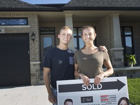 Andre Portovedo, left, and Danielle Bacci, who moved away from the Toronto area in January 2019, pose for a portrait in front of their new home in Kingsville, Ont., Thursday, May 23, 2019.