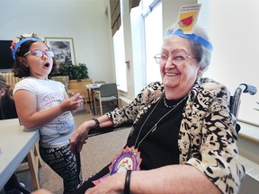 Forest Glade School student Mira Krndija, 6, shares a laugh while playing a guessing game with Evelyn Talbot, 94, a resident at the Riverside Place Long Term Care Home on Thursday, May 30, 2019. They're participating in a school enrichment program that allows youngsters and seniors to spend time together.