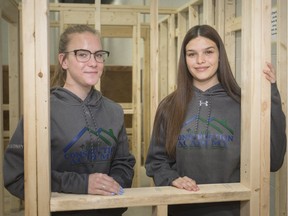 Maggie MacDonald, 17, left, and Shelby Dunn, 17, who are graduating from the Construction Academy at St. Joseph's Catholic High School, are pictured during a ceremony, Thursday, May 16, 2019.