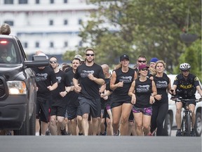 The 2019 Law Enforcement Torch Run proceeds south on Ferry Street in downtown Windsor, Tuesday, May 28, 2019.