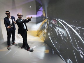 Ryan Gilleran, left, applications engineer at ANSYS, Inc., shows a virtual reality cave to Tal Czudner, a board member of WindsorEssex Economic Development Corporation, Wednesday, May 29, 2019 at the Institute for Border Logistics in Windsor.  The VR CAVE is used in the development of a Canadian prototype vehicle.