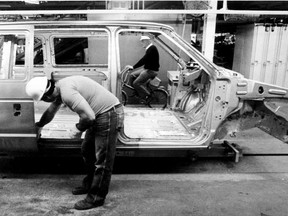 Rich Gauthier installs the sliding door on a new Chrysler minivan in this file photo from Oct. 7, 1983.