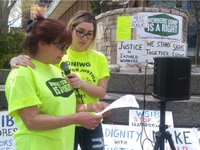 Kim Baptie, left, is assited by  Renee Sauve during a workers rights rally at Charles Clark Square in Windsor on Tuesday, May 14, 2019.