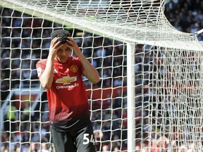 Manchester United's Mason Greenwood reacts after missing a chance to score during the English Premier League soccer match between Manchester United and Cardiff City at Old Trafford in Manchester, England, Sunday, May 12, 2019.