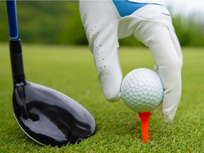 A golfer prepares to hit a tee shot.