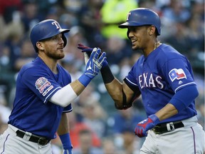 Ronald Guzman #11 of the Texas Rangers celebrates his solo home run with Elvis Andrus #1 during the sixth inning of a game against the Detroit Tigers at Comerica Park on June 25, 2019 in Detroit, Michigan.