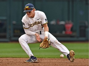 Jack Blomgren of the  Michigan Wolverines mis-plays a ground ball in the fifth inning against the Vanderbilt Commodores during game two of the College World Series Championship Series on June 25, 2019 at TD Ameritrade Park Omaha in Omaha, Nebraska.