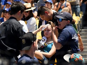 An injured fan is escorted on a stretcher after she was hit by a foul ball off the bat of Cody Bellinger #35 of the Los Angeles Dodgers during the first inning against the Colorado Rockies at Dodger Stadium on June 23, 2019 in Los Angeles, California. (Photo by Harry How/Getty Images)