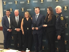WFCU CEO Eddie Francis, St. Clair College Foundation board member Dave Moncur, Shelley Atkinson, scholarship winner Daniel Zeleny, scholarship winner Andie Suthers, Police Chief Al Frederick (left to right) are seen during a regular Police Board meeting.
