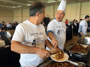 Volunteers Martin Sobocan (right) and Marc Beausoleil lend their hands to serve up sandwiches during the 43rd annual Poor Boy Luncheon at the St. Clair Centre for the Arts on June 7, 2019.