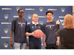 University of Windsor Lancers men's basketball head coach Chris Cheng, centre, added local recruits Akot Aken, left, and Kassen Chiang-Byas for the 2019-20 season.