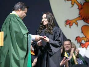 Kiara Clement, right, receives the Student Leadership Medal from Ron Seguin during St. Clair College of Applied Arts and Technology 52nd Annual Convocation held this year at WFCU Centre Tuesday.