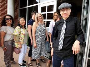 Keynote speaker and doorman Ehab Heleeji, right, greets some of the 400 loyal guests of Family Respite Services at St. Angela Merici Hall for the 20th annual Walk on Erie Street event Monday.  Heleeji, 17, is living with autism and has been receiving assistance from Family Respite for eight years.