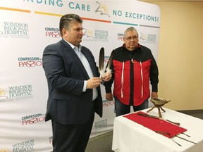 David Musyj, president and CEO of Windsor Regional Hospital, is presented with eagle feathers by Michael Hopkins from Delaware First Nation during a ceremony at the Windsor Regional Hospital on Tuesday, June 18, 2019.