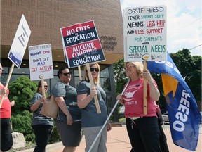 OSSTF members walk with protest signs against job cuts in front of the Greater Essex County School Board offices on Park Street West.  The "No Cuts to Education" rally attracted dozens of protestors and local MPP Percy Hatfield (not shown).