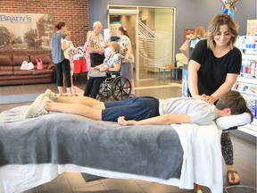 Registered massage therapist Rita Kako, standing right, works on a patient during the official Open House of the new Rural Health Hub, Essex Medical Centre on Talbot Street South. The Walk-in Clinic waiting room section of the Rural Health Hub is named after Dr. Lee Michael Luciani, who was one of the founding members of the Essex Medical Centre on Talbot Street South. Physicians, dentists, nurse practitioners, pharmacists and registered massage therapists at the newly established Rural Health Hub welcomed the public to view the innovative centre which provides coordinated access to healthcare Wednesday.