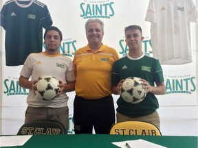 St. Clair Saints men's soccer coach Mike Baraslievski is photographed with Andrew Ribeiro (left) and Massimo Pollard.
