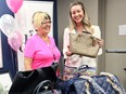 Gale Simko-Hatfield, left, and Honourary Chairperson Meighen Nehme at official Kick-Off for the annual Handbag for Healthcare Campaign on Wednesday June 26 at the Canadian Mental Health Association, Windsor-Essex County Branch (CMHA-WECB) located at 1400 Windsor Ave. In photo, the first donated handbags were accepted during the Kick-Off event.
