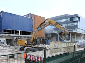 Demolition of old City Hall, left, by Budget Demolition Wednesday. Windsor's new City Hall building is shown at right.