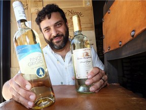 Adriano Ciotoli with Pinot Grigio from Sprucewood Shores (Ontario) and Santa Margherita (Italy) at Wineology on Wyandotte Street East.  Ciotoli, co-owner of WindsorEats has worked with the owners of Wineology to set up an international wine list for the upcoming Wine Festival.
