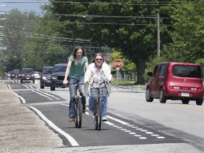 A couple of cyclists use the recently installed bike lanes along Totten Street in Windsor on June 6, 2019. The lanes are part of the city's active transportation plan.