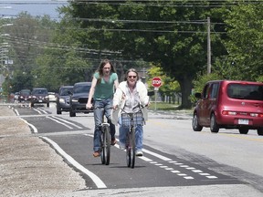 A couple of cyclists use the recently installed bike lanes along Totten St. in Windsor on June 6, 2019. The lanes are part of the city's Active Transportation Plan.