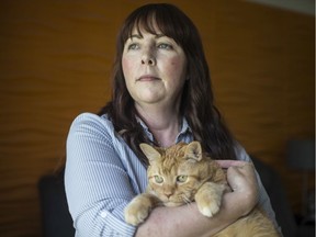 Amy Fitzgerald, associate professor and acting department head of Sociology, Anthropology and Criminology, is pictured with her 15-year-old cat, Zoe, at her home, Friday, June 28, 2019.