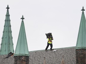 A worker is shown on the roof of the Assumption Church in Windsor on Tuesday, June 4, 2019. Renovation work to the historic structure is in full swing.