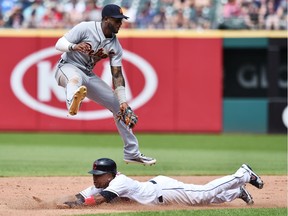 Cleveland Indians third baseman Jose Ramirez steals under the tag attempt of Detroit Tigers shortstop Niko Goodrum during the eighth inning at Progressive Field.