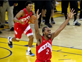 Toronto Raptors forward Kawhi Leonard and Toronto Raptors guard Kyle Lowry celebrate winning the NBA Championship over the Golden State Warriors against game six of the 2019 NBA Finals at Oracle Arena.