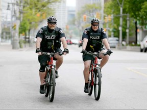 Const. Angus McKenzie (L) and Const. Gary Boudreau (R) of the Windsor Police Service City Centre Patrol ride around the core in this May 2017 file photo.