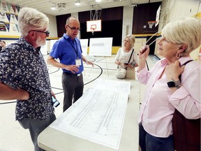 David Archer, second from left, an engineer with RC Spencer Associates Inc. speaks with Bike Windsor Essex members Darren Winger, Lori Newton, centre, and Jennifer Escott at a public information session for the Phase 2 of the Cabana Road East infrastructure improvement project. The event was held at the Roseland Public School on Wednesday, June 5, 2019.