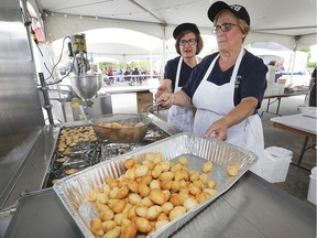 Dina Trintafillos, left, and Flora Trifon cook up the popular honey balls at the Carrousel of Nations Greek Village at the Holy Cross Greek Orthodox Church in Windsor, ON. on Friday, June 14, 2019.