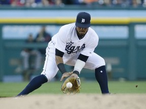 Third baseman Dawel Lugo of the Detroit Tigers fields a grounder hit by Jake Bauers of the Cleveland Indians and throws out Kevin Plawecki at second base during the second inning at Comerica Park on June 15, 2019 in Detroit, Michigan. The Indians defeated the Tigers 4-2.