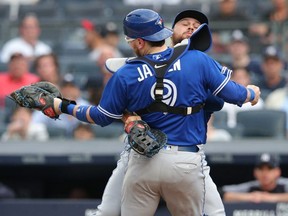 Blue Jays catcher Danny Jansen (9) collides with Blue Jays first baseman Rowdy Tellez (behind) after catching a pop up by Yankees catcher Gary Sanchez during first inning MLB action at Yankee Stadium in New York on Tuesday, June 25, 2019.