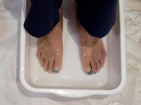 A customer soaks her feet in a salt bath at a spa in Montreal in this 2017 file photo.