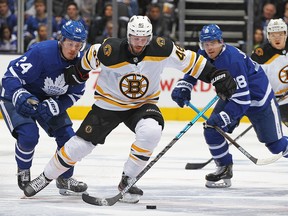 David Krejci of the Boston Bruins skates between Kasperi Kapanen and Andreas Johnsson of the Toronto Maple Leafs at Scotiabank Arena on April 15, 2019 in Toronto. (Claus Andersen/Getty Images)