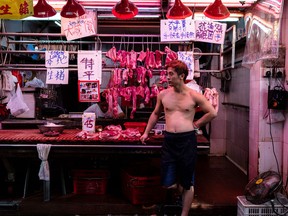 A butcher stands at a meat store in Hong Kong, China, on Saturday, June 22, 2019.
