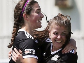L'Essor's Gabrielle Lehoux, left, and Maggi Dewolf-Russ celebrate a goal against the Kenora Beaver Brae in pool play at Friday's OFSAA girls' AA soccer championship in Tecumseh.