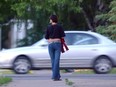 A prostitute works a corner in Edmonton, Alberta, in this June 2005 file photo.