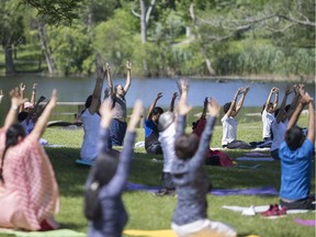 People practice yoga at an event celebrating International Day of Yoga at Malden Park, Saturday, June 22, 2019.