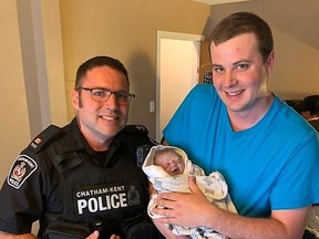 Handout/Chatham Daily News Chatham-Kent police Const. Gary Oriet experienced a first in his policing career so far when he helped deliver a baby on Tuesday. The officer is pictured with the proud father and his daughter, whose names were not released.